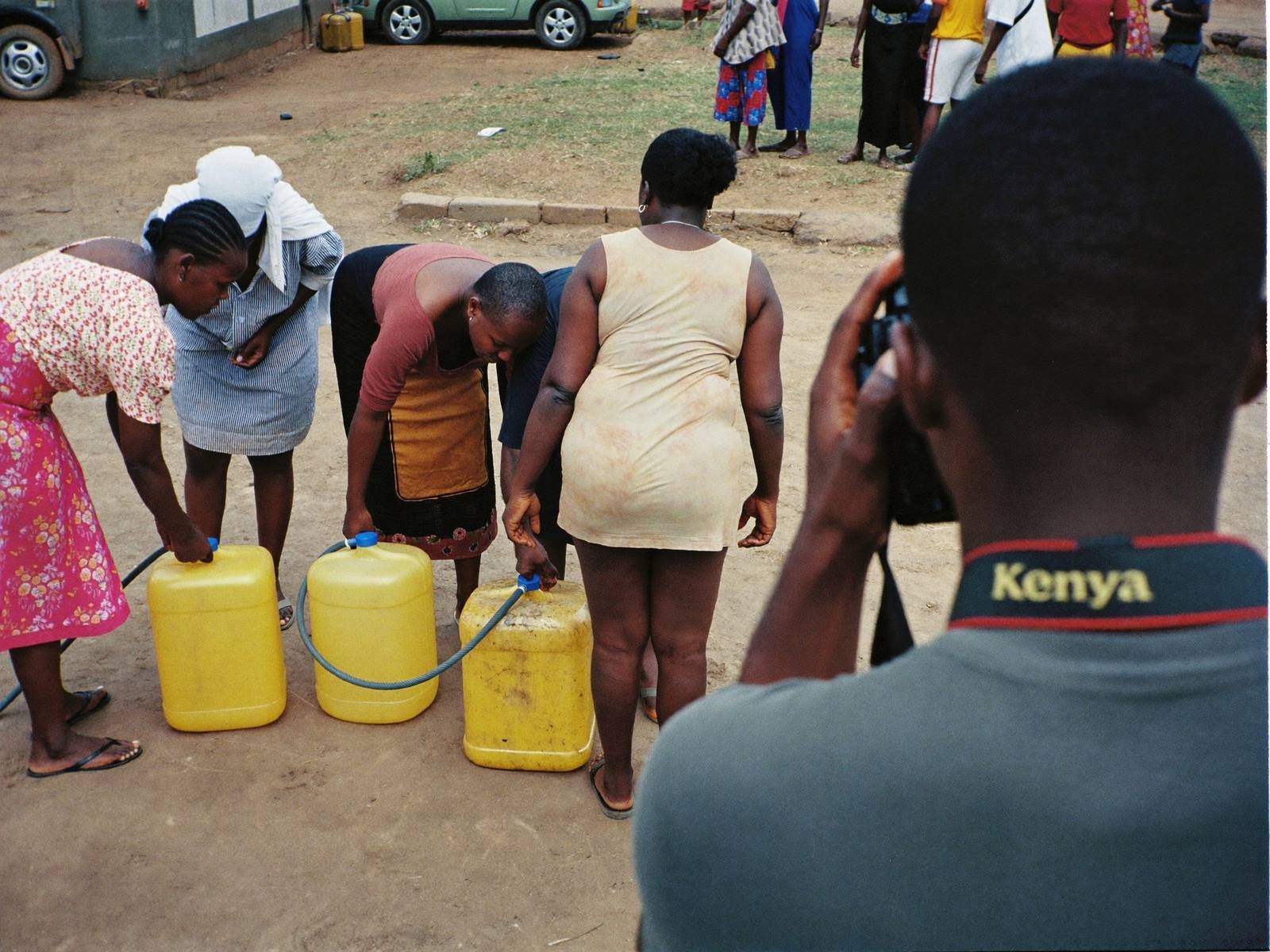 Photographer documenting a community water point