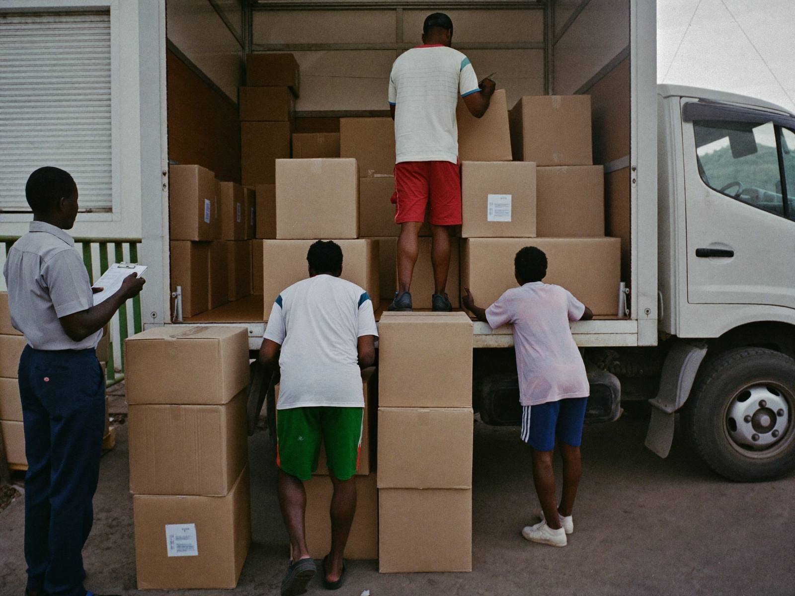Supplies being loaded onto a truck at a warehouse