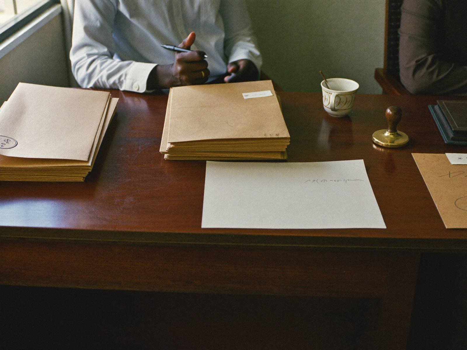 Officials reviewing documents at a desk